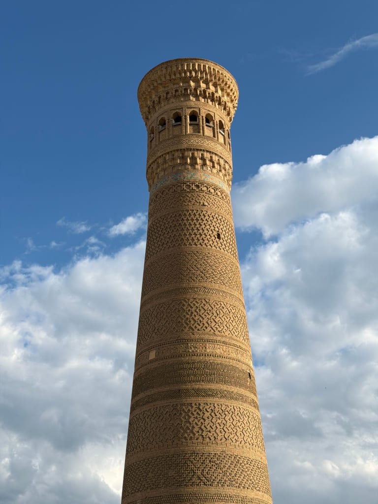 Kalyan Minaret in Bukhara, Uzbekistan, against a blue sky