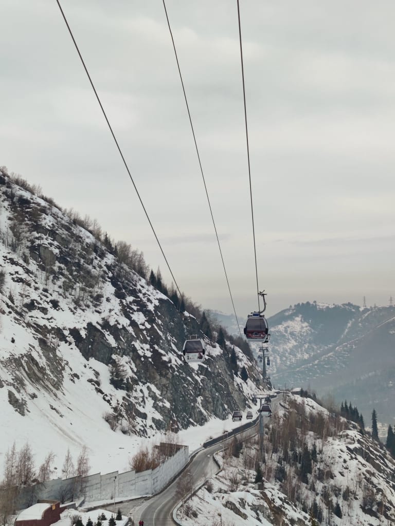 Cable cars above the snowy Almaty mountains in winter
