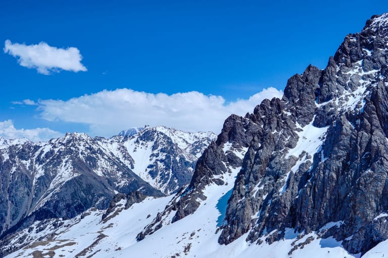 Snow and rock peaks of the Ile-Alatau above Almaty, the mountains of the Bogdanovich Glacier hike