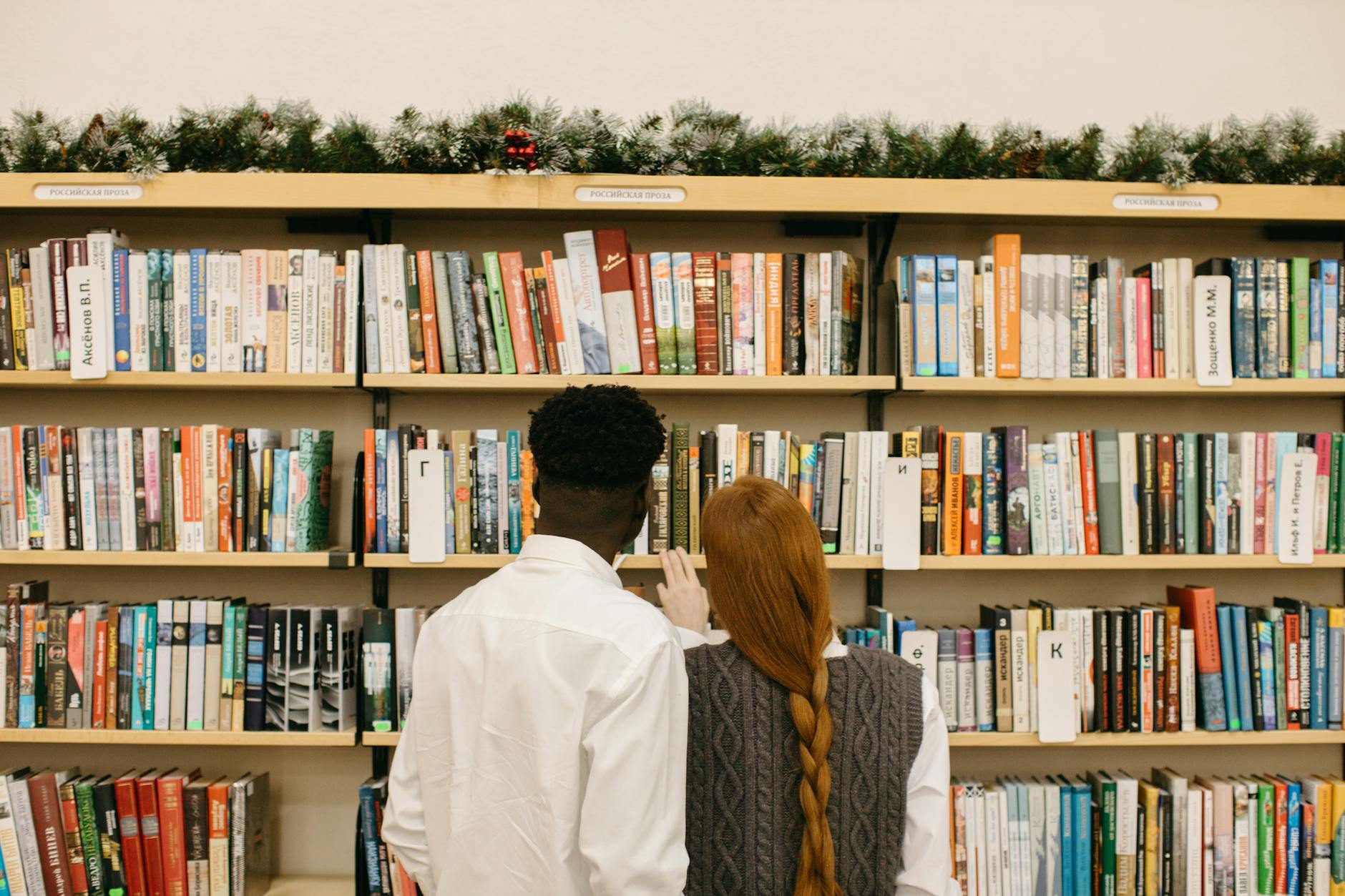Couple browsing bookshelves together in a library