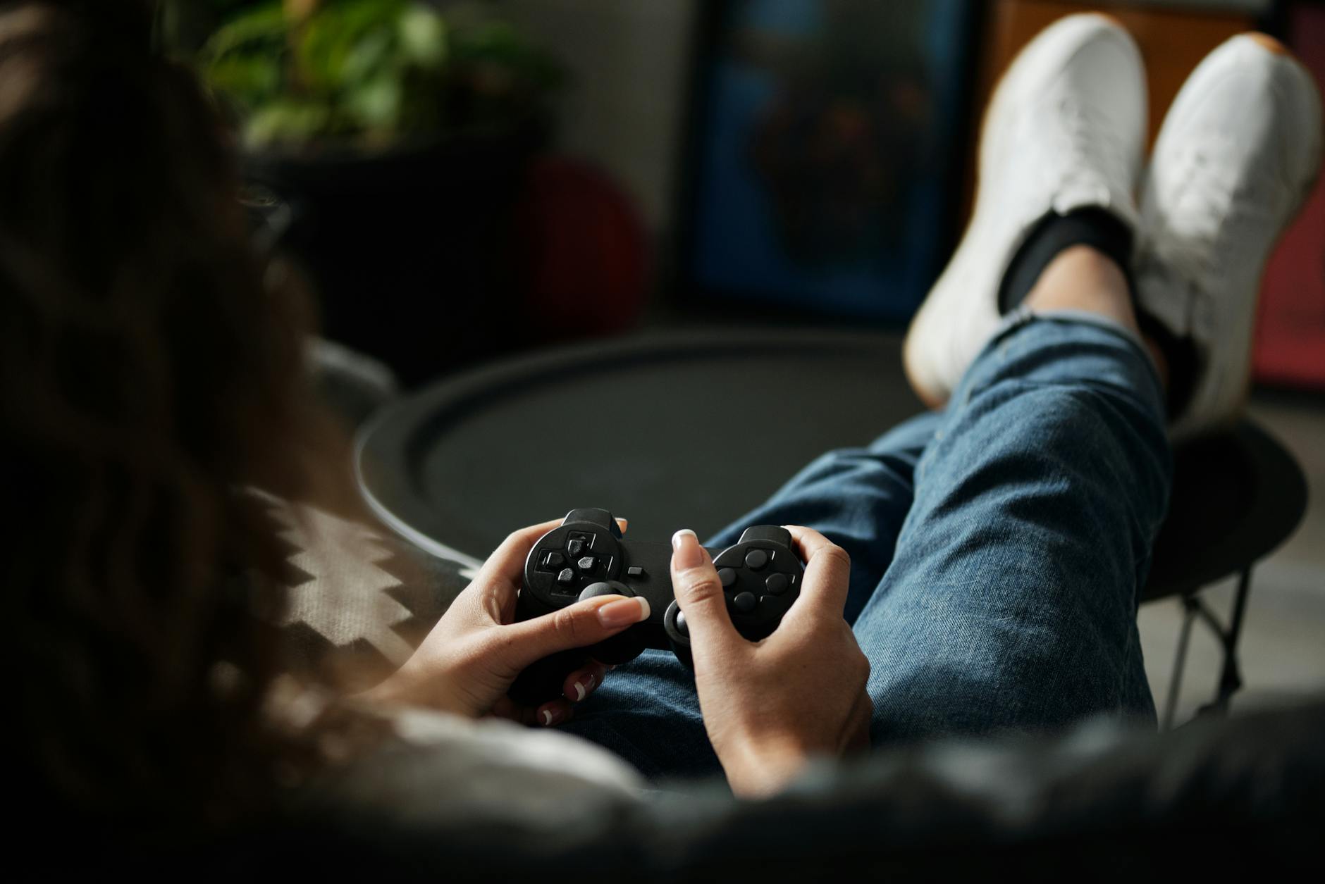 Person relaxing with a game controller, ready to play