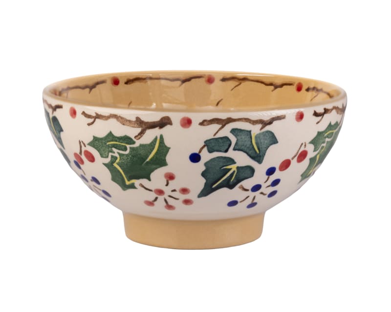 Hand-painted ceramic bowl with holly leaves, ivy, and berries in festive Christmas design with tan interior