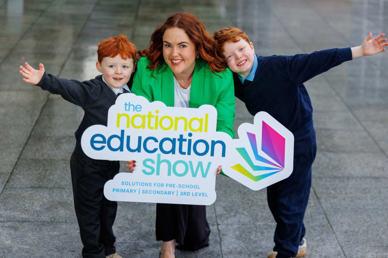 Bobby Flood, Rebecca Dunwoody and Archie Flood holding National Education Show sign