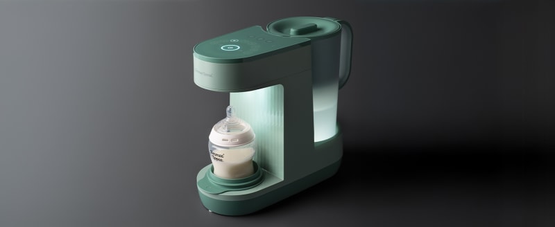 Sage green Perfect Prep baby formula machine with illuminated water tank and bottle