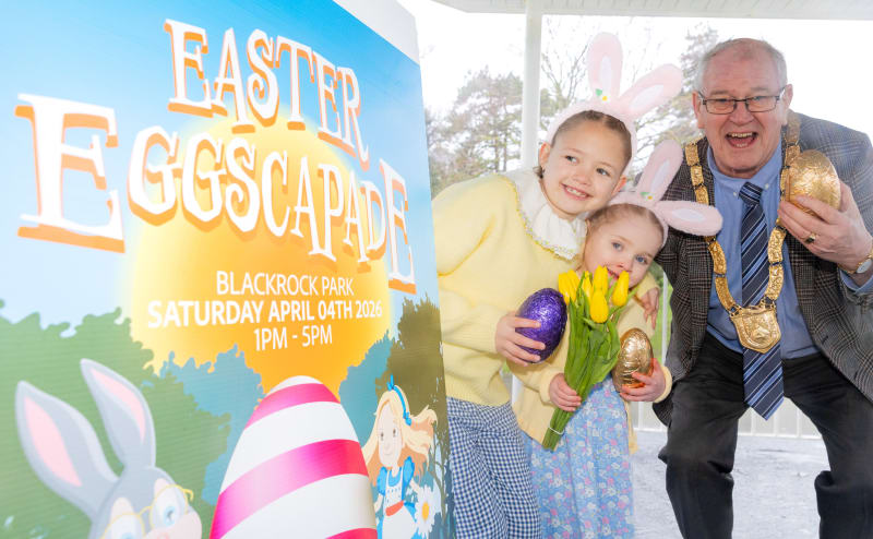 Two girls with bunny ears and man with mayoral chain promote Easter Eggscapade event at Blackrock Park
