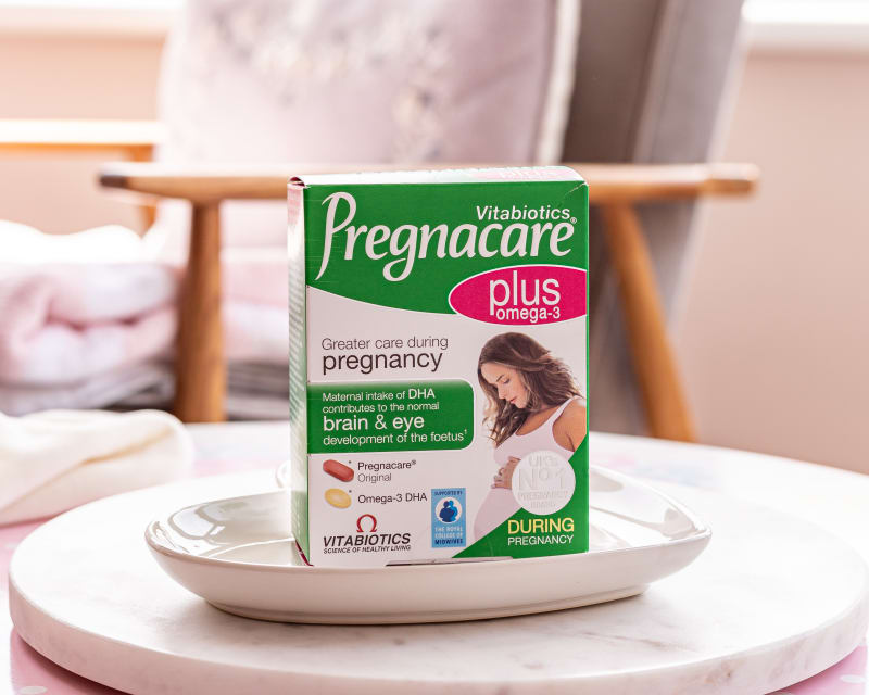 Vitabiotics Pregnacare Plus Omega-3 pregnancy supplement box on a white ceramic dish on a marble side table.