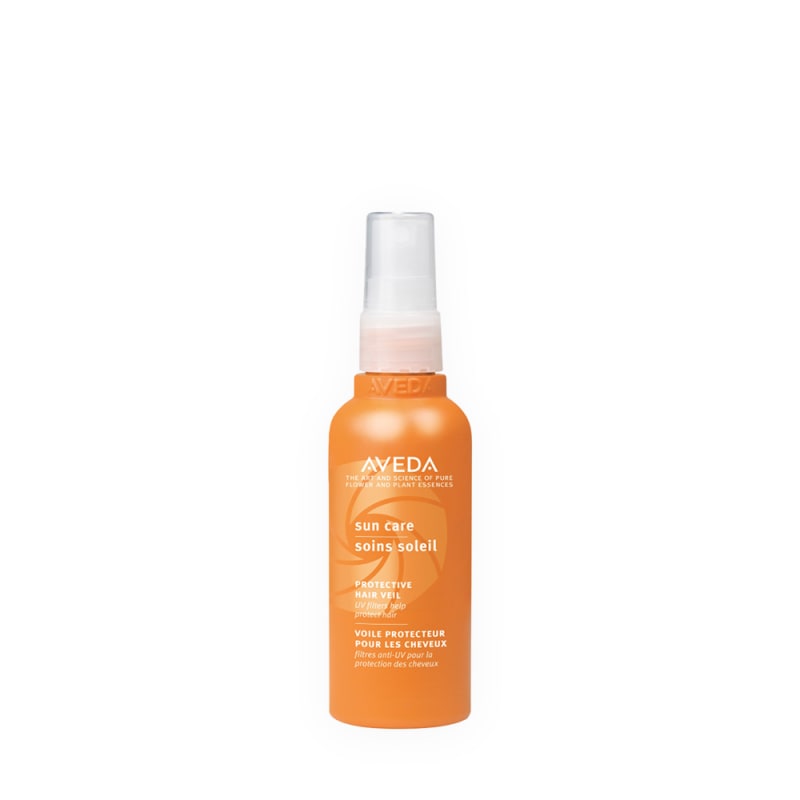 Aveda Sun Care Protective Hair Veil orange pump spray bottle with UV filters for hair protection.