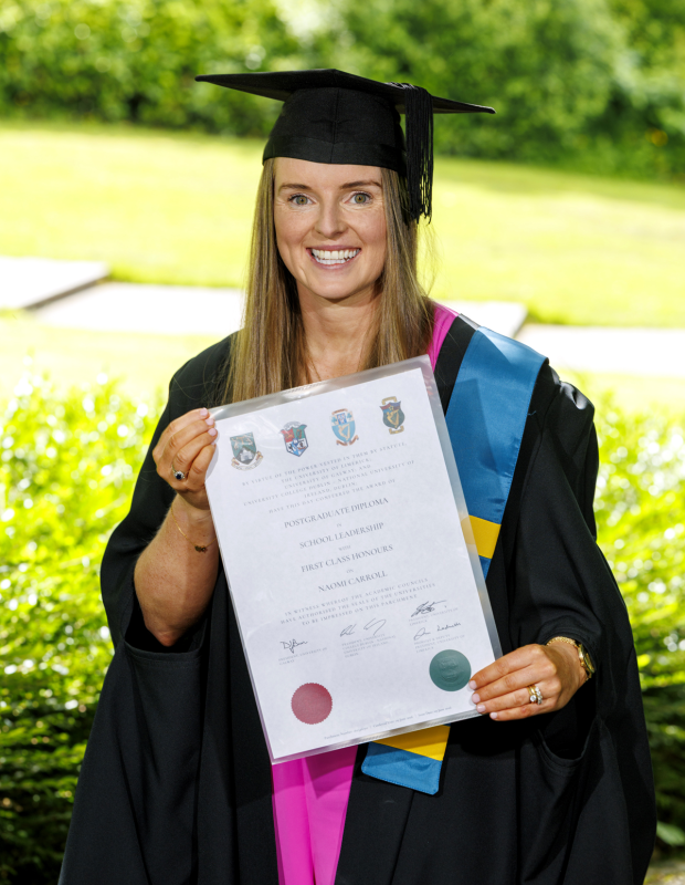 Naomi Carroll holding her Postgraduate Diploma in School Leadership with First Class Honours certificate at graduation.