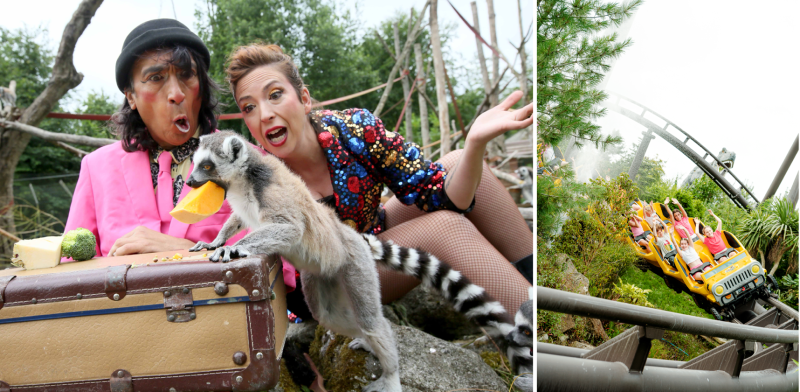 Costumed performers react to a ring-tailed lemur at a wildlife attraction, alongside a yellow jeep roller coaster ride.