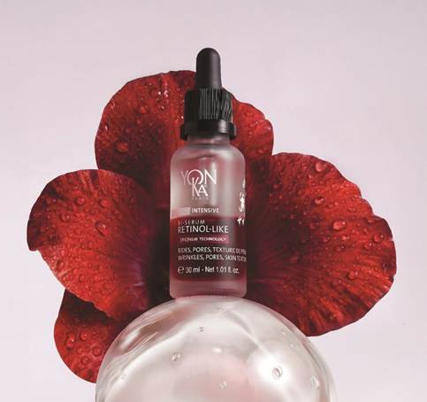 Yon-Ka Paris Intensive Retinol-Like B-Serum 30ml dropper bottle resting on a glass sphere with red flower petals.