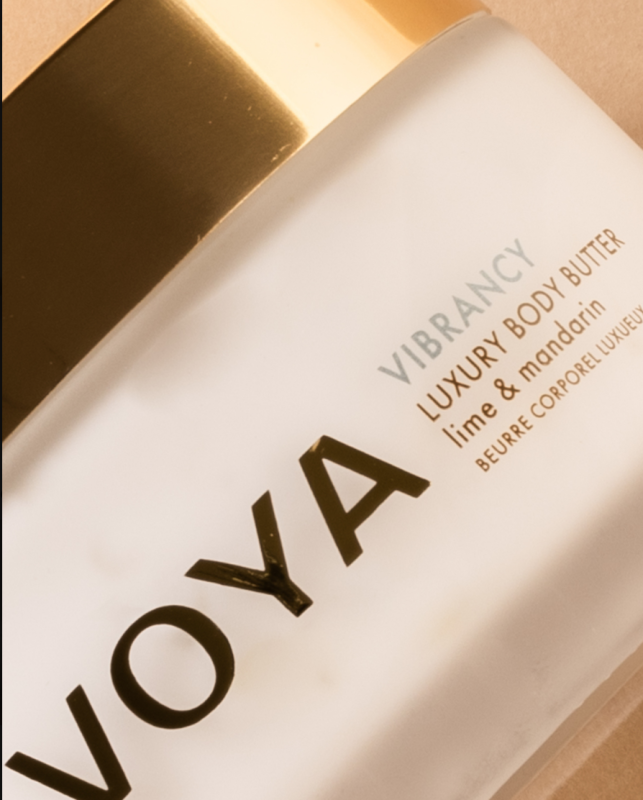 VOYA Vibrancy Luxury Body Butter in lime and mandarin, frosted white bottle with gold branding.