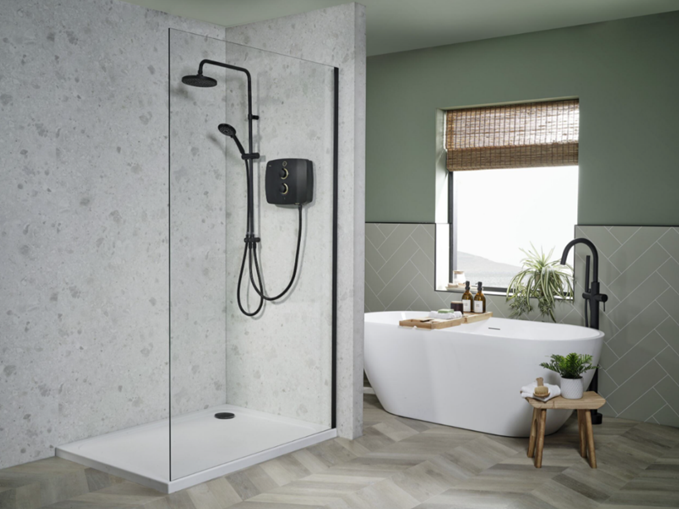 Modern bathroom with black electric shower system in walk-in enclosure and freestanding white oval bathtub.