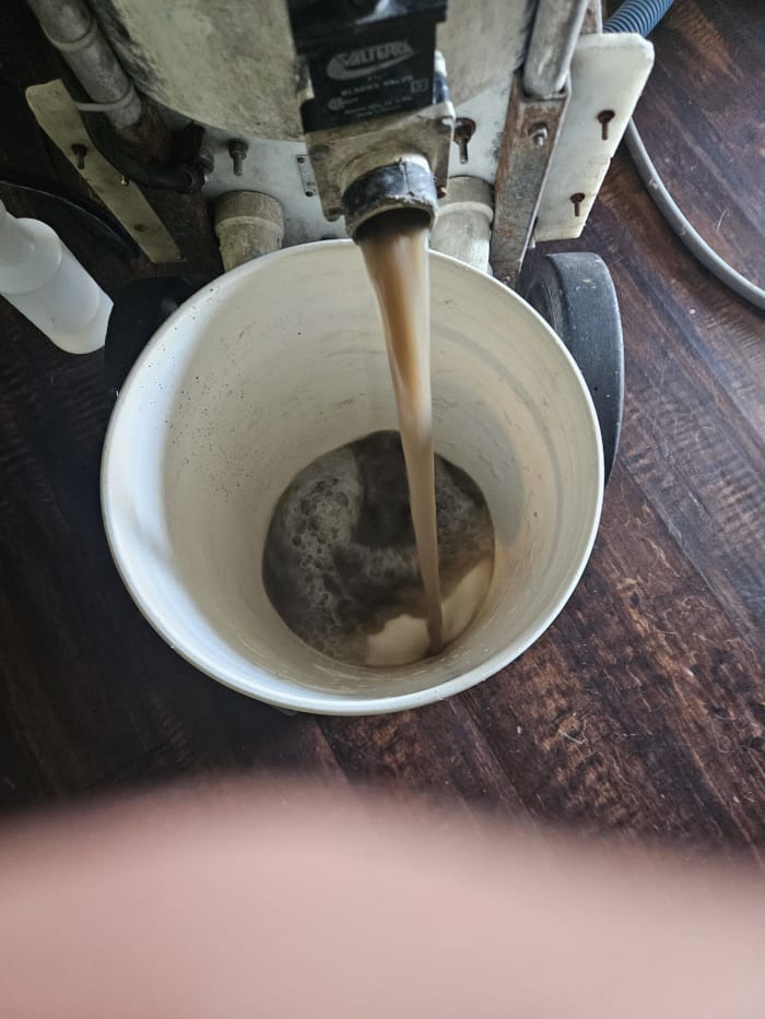 Carpet extractor emptying dirty water