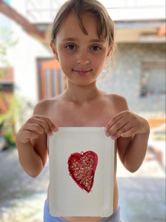 A girl standing with a heart