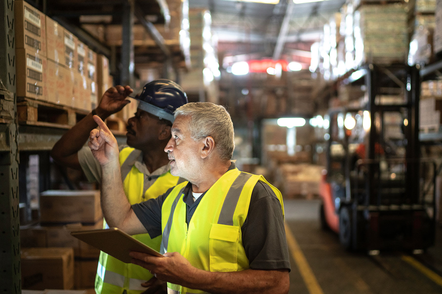 Workers in warehouse using tablet