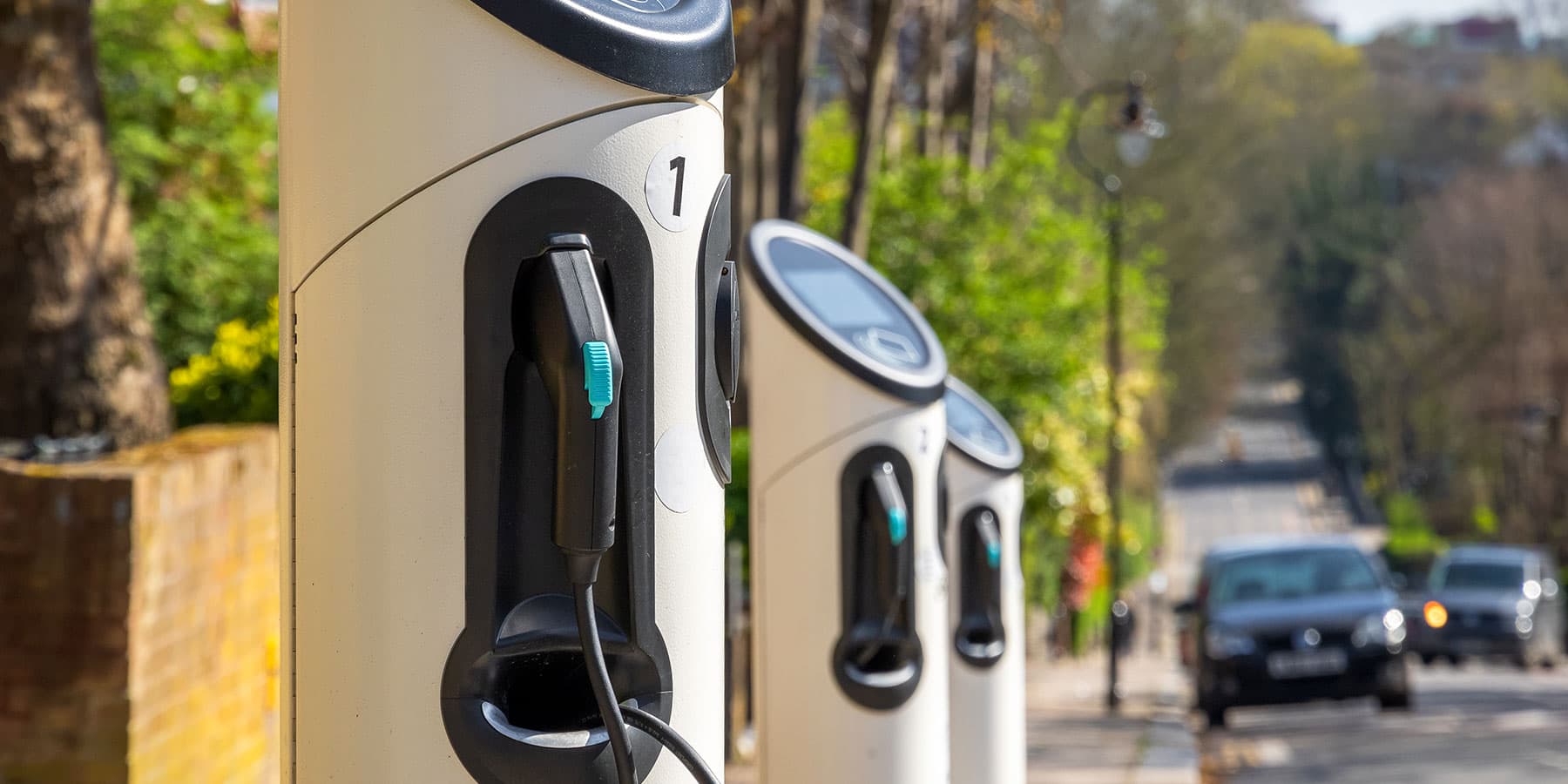 Row of EV chargers on the street.