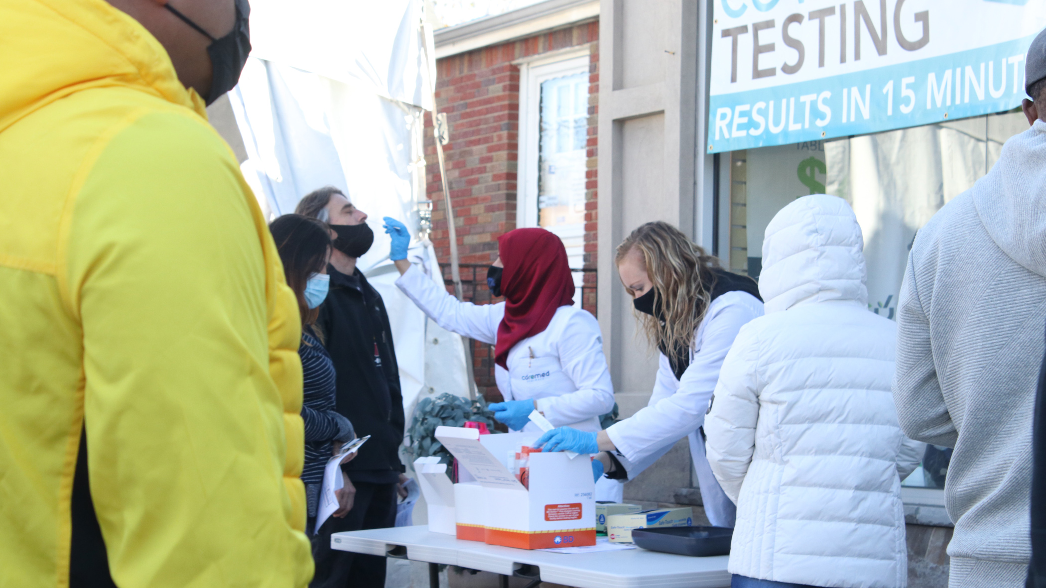 People getting COVID tests at an outdoor testing station