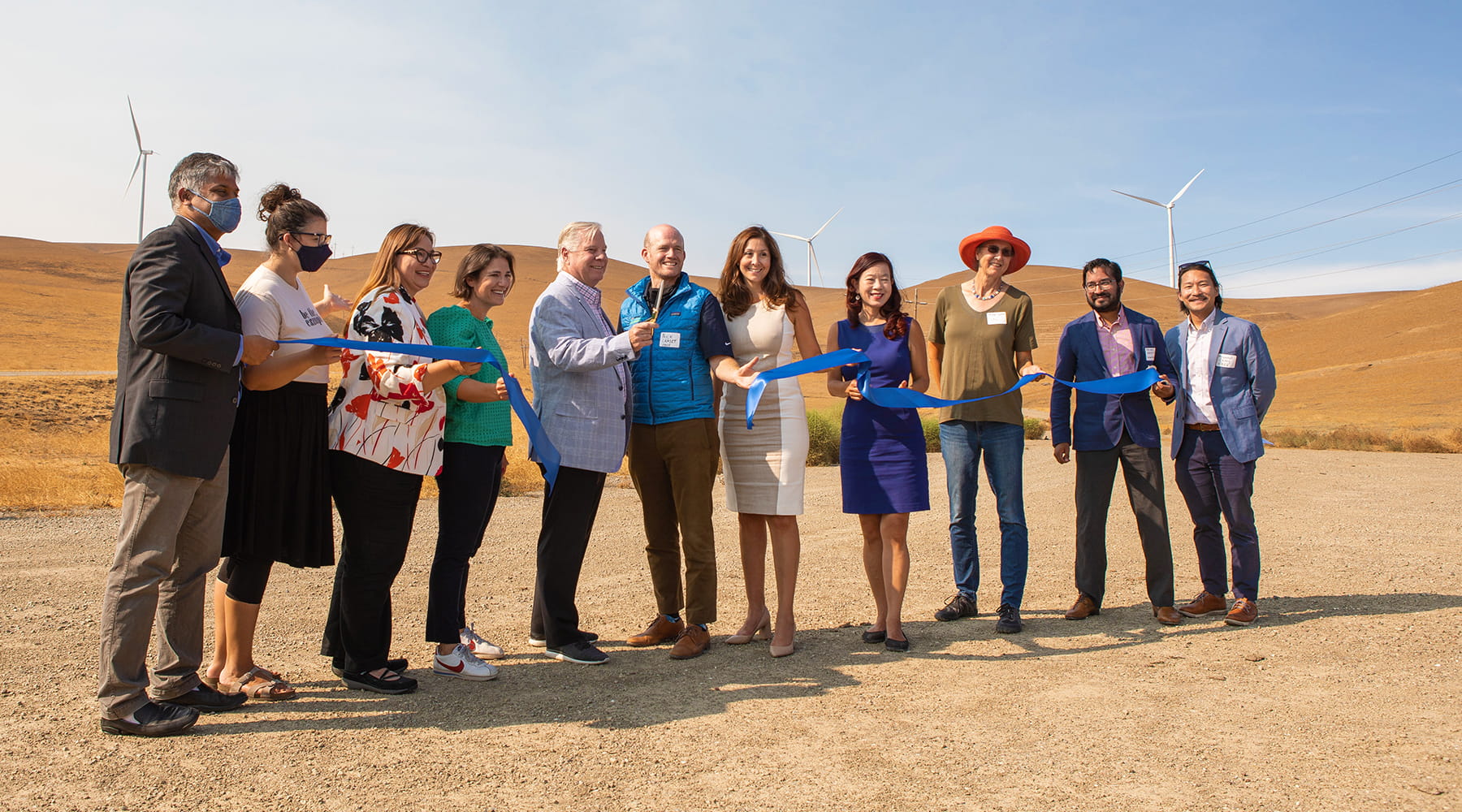 EBCE team members cutting ribbon in front of wind energy center