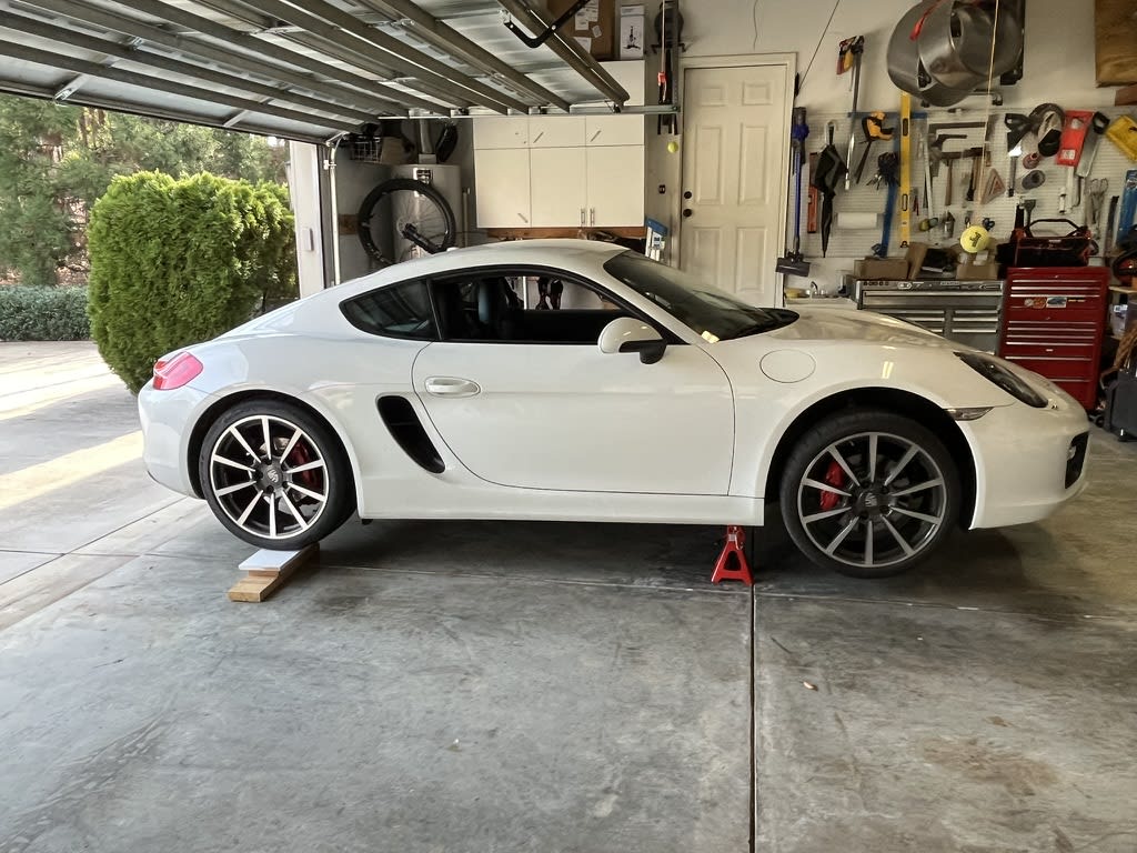 Pleace a 4x6 block under the rear tire (or a stack of wood) and slowly lower and remove the jack.