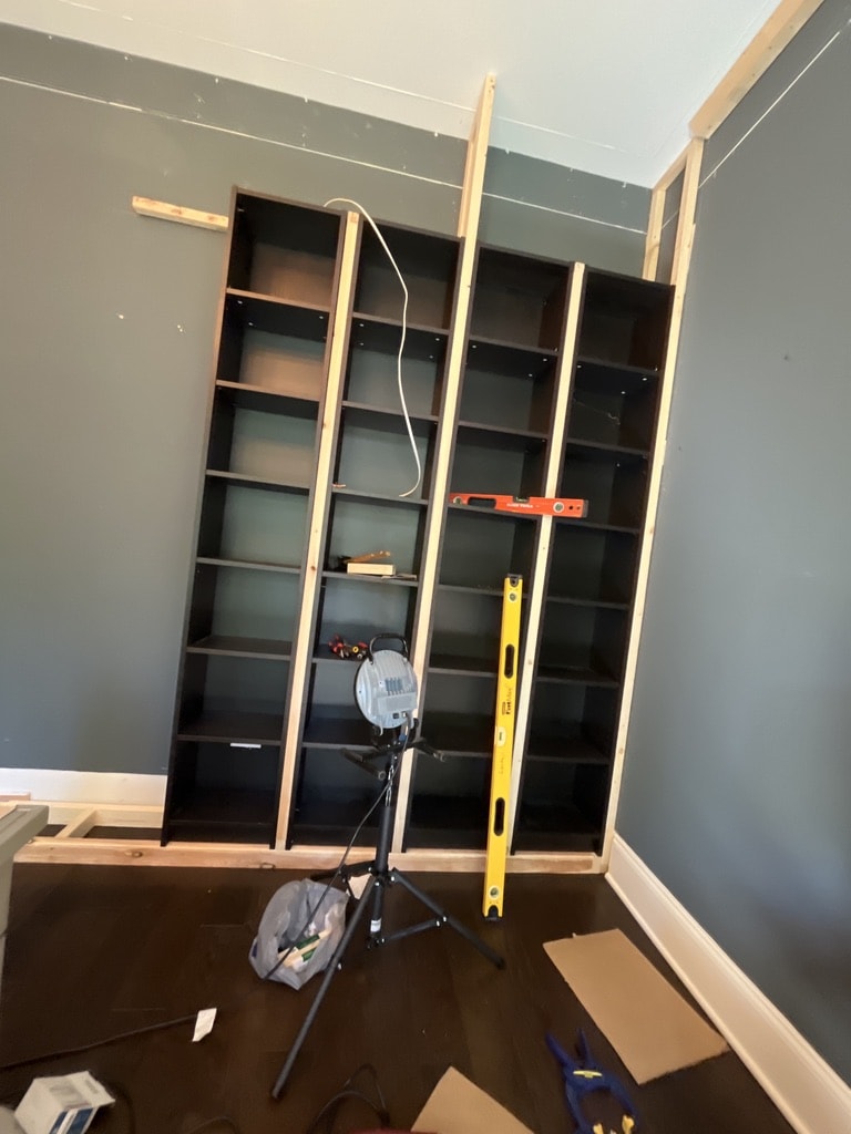 I expanded the outlet to a double gang and installed a wireless dimmer/controller in the second slot. You can barely see this in the bottom left shelf. Here the light has been pulled through the wall into the future void above the shelves.