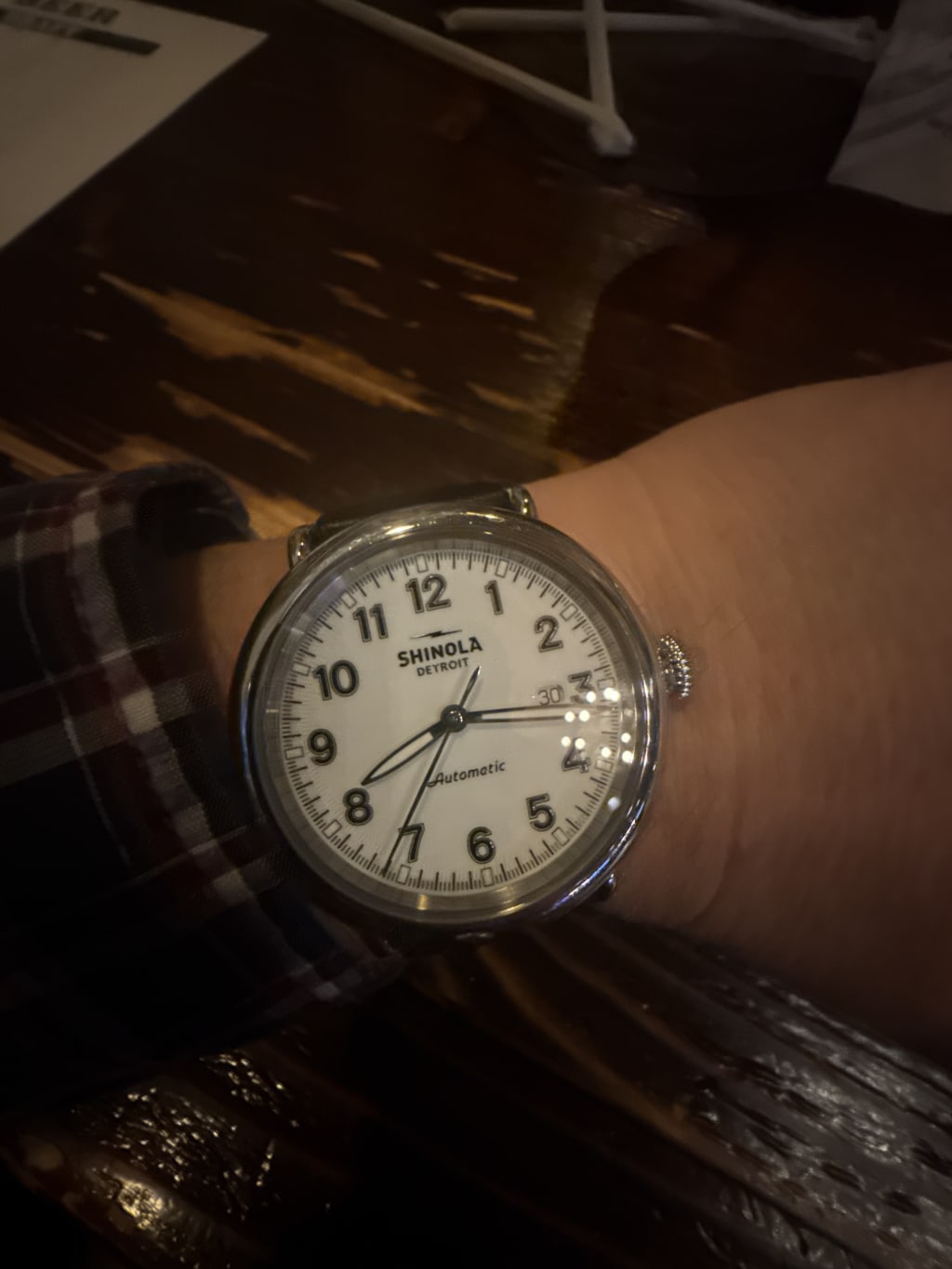 A wristwatch displaying 8:15 with the brand "Shinola Detroit" on the dial.