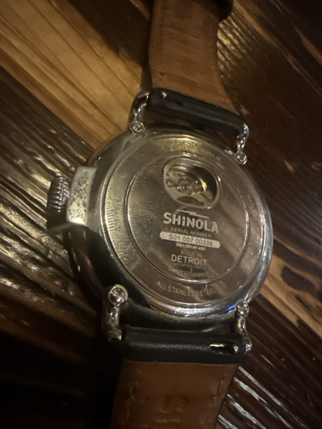 The back of a Shinola watch showing serial number and "Built in Detroit" engraving.