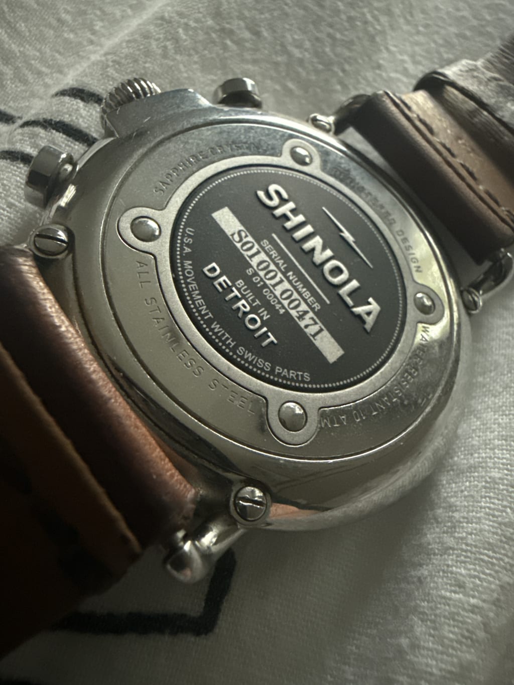 Close-up of a Shinola watch back, highlighting the Detroit-built craftsmanship and serial number.