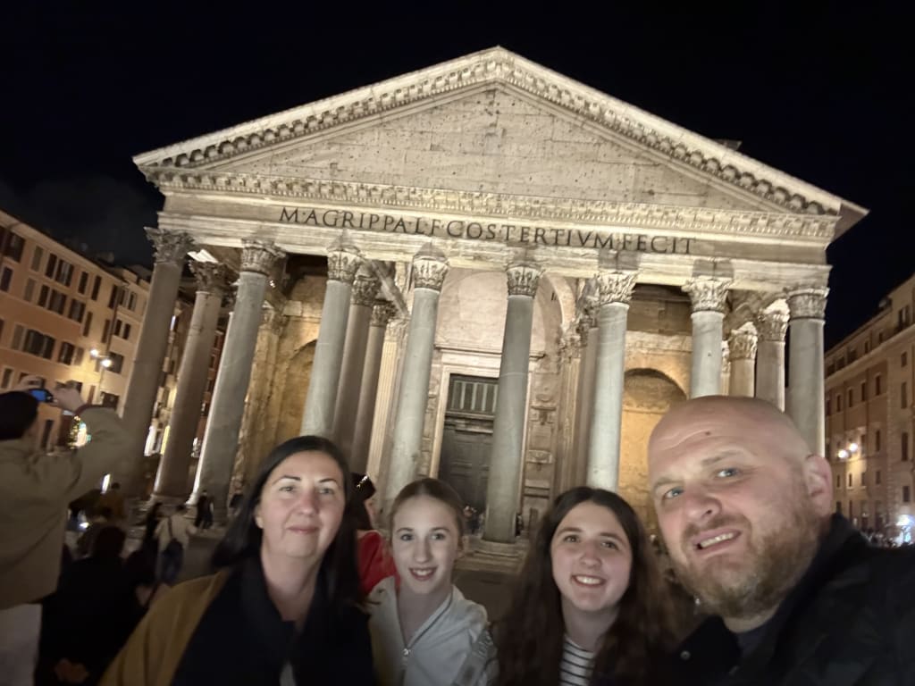 The Gales take a family nighttime selfie in front of the illuminated Pantheon in Rome.
