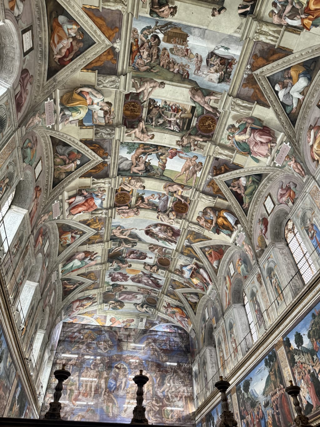 The ceiling of the Sistine Chapel adorned with Michelangelo's detailed Renaissance frescoes.