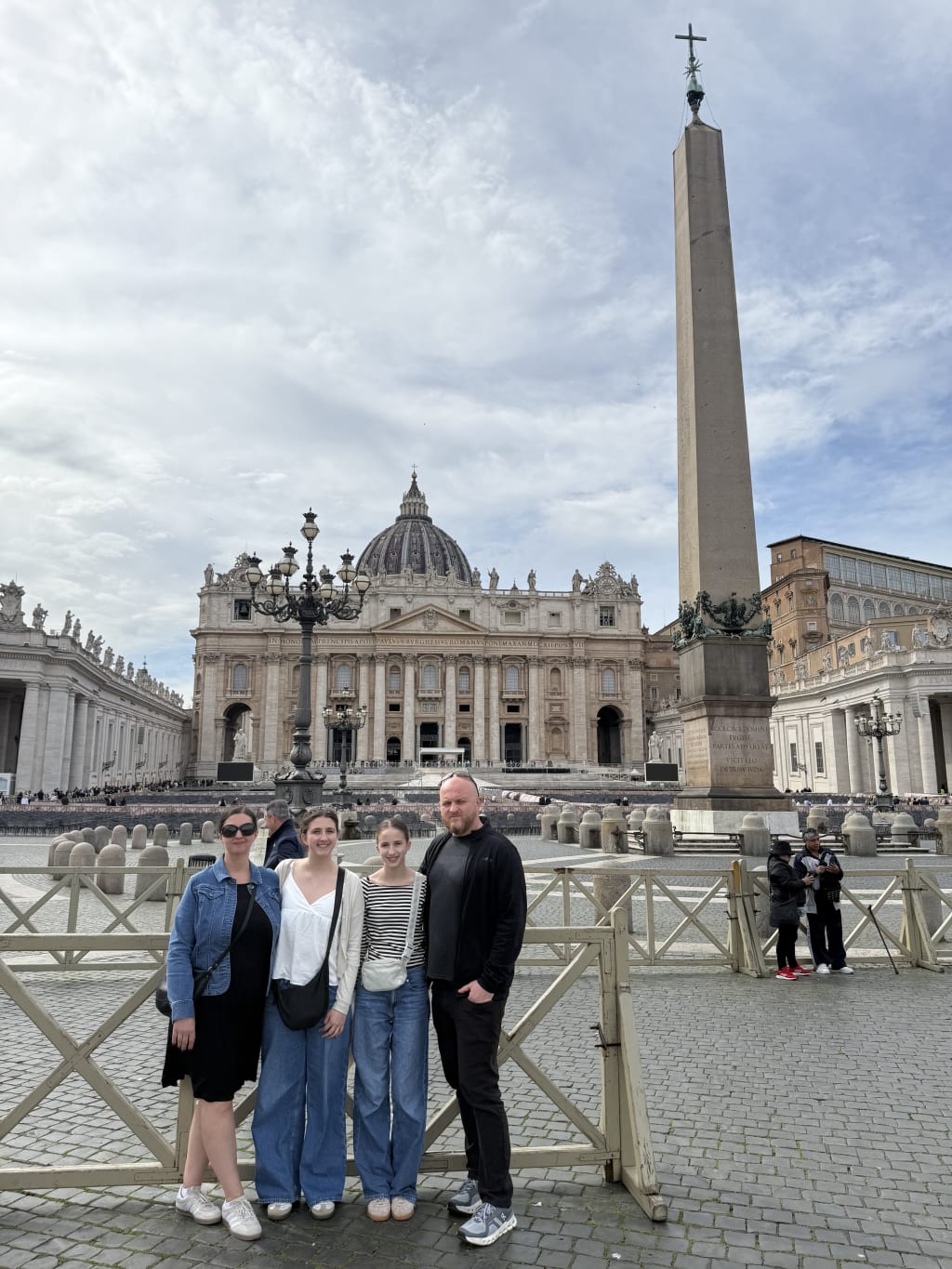 We are posing in front of St. Peter's Basilica and the Vatican Obelisk.