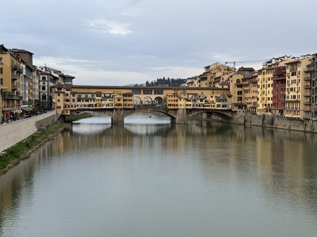 The Ponte Vecchio bridge in Florence, Italy, with buildings over the Arno River.
