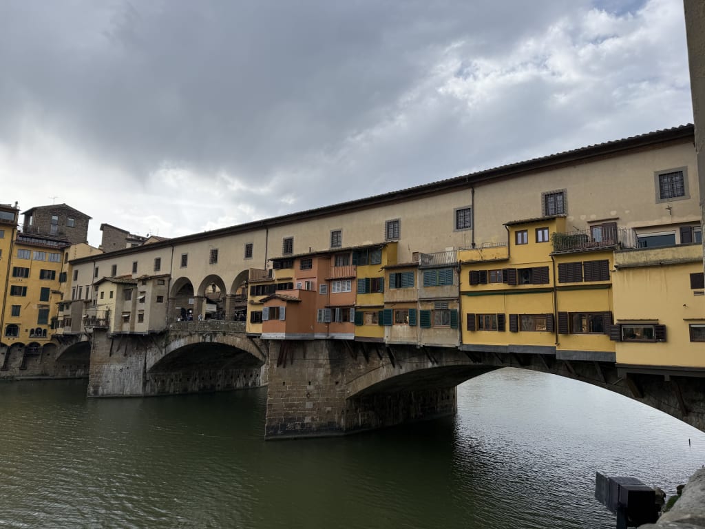 The Ponte Vecchio, a historic medieval stone bridge over the Arno River in Florence, Italy.
