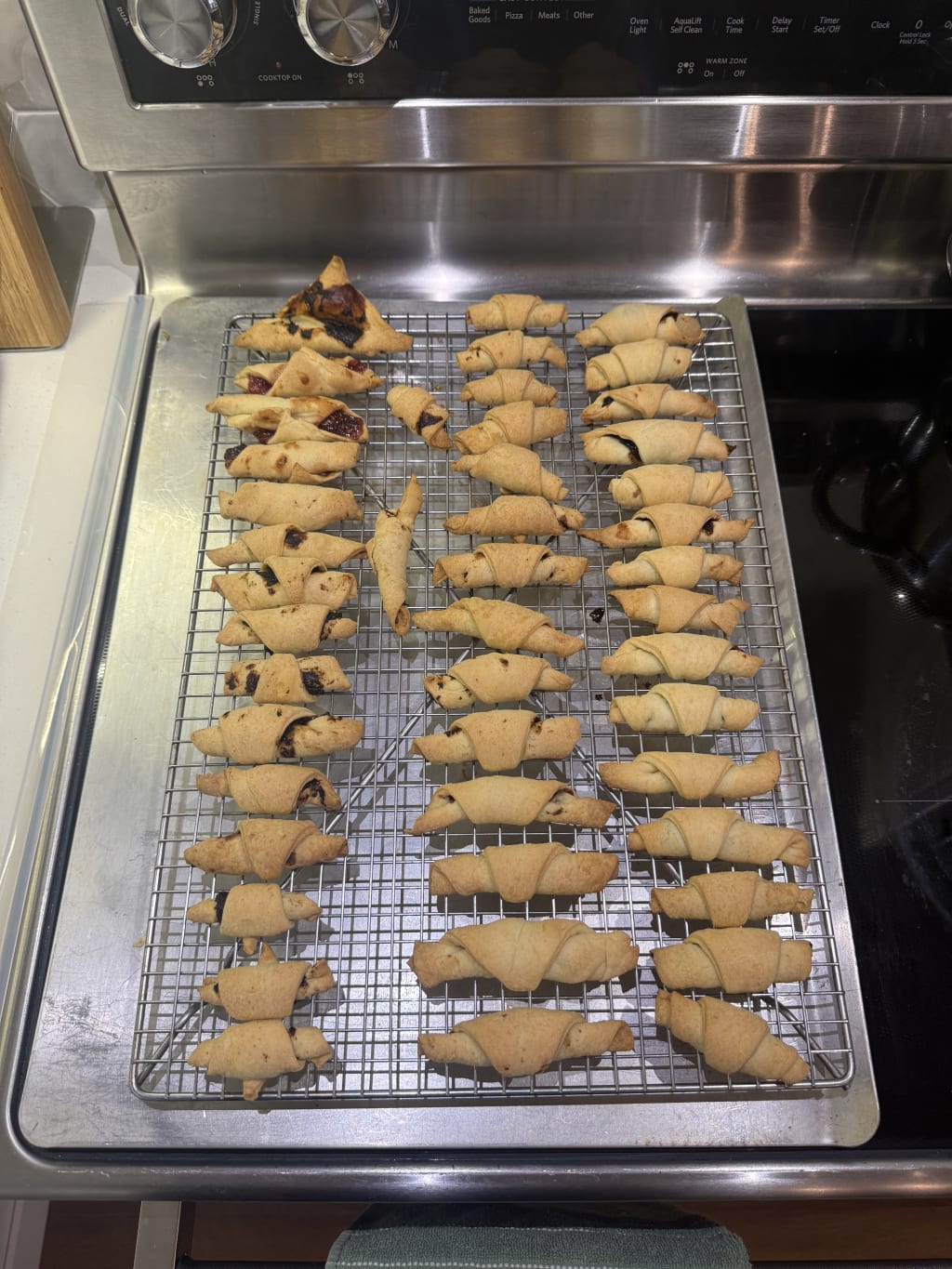 These are 'Cornulețe' in Romanian, probably best translated as 'tiny croissants'.  This is right as they came out of the oven, before they get the pretty dusting of fine sugar.  