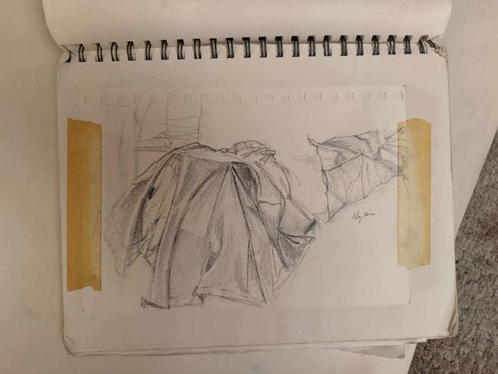 A quick sketch of table cloth laying on a corner of a table.