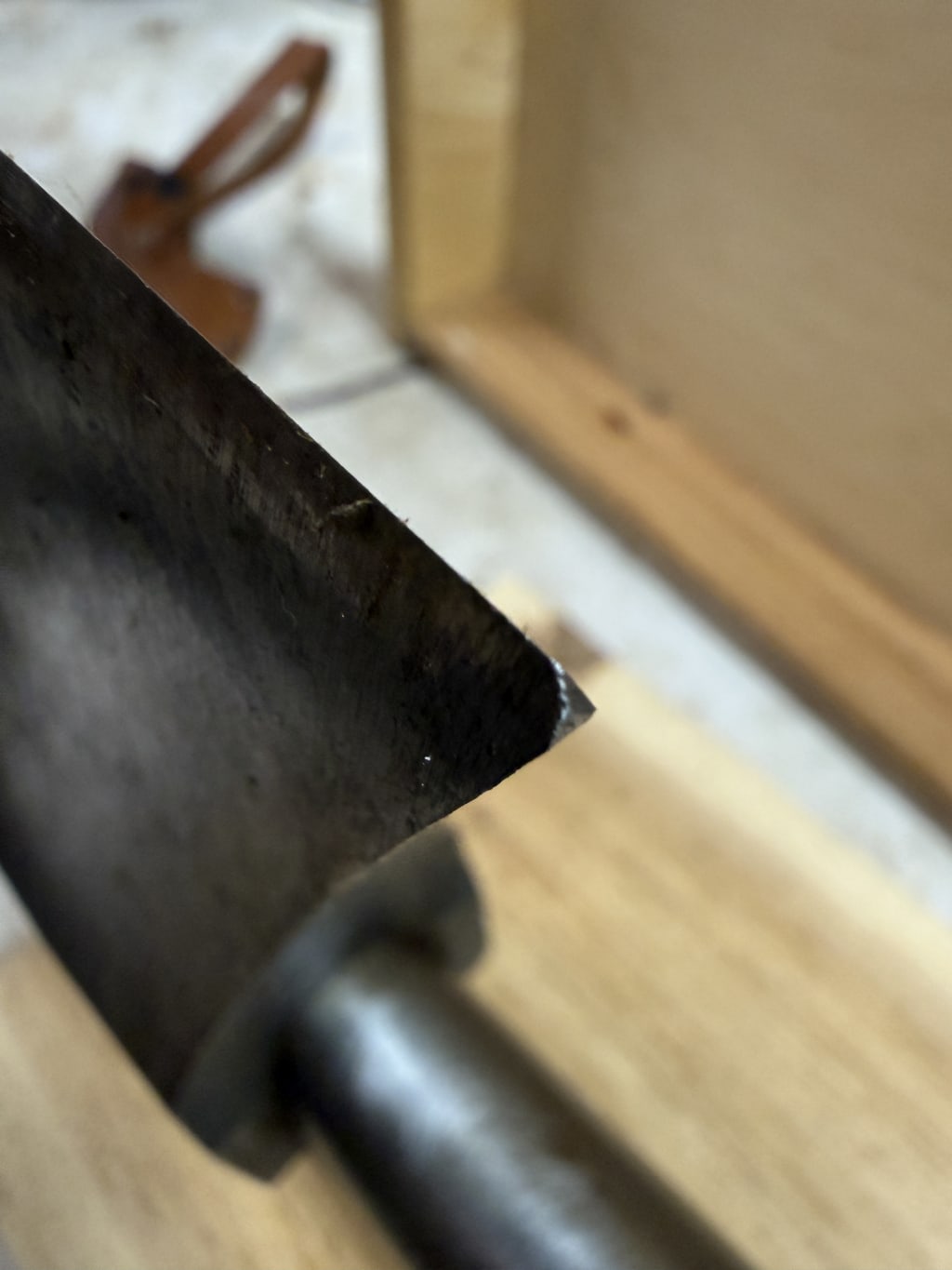 I read that this axe, after it gets finished, the blacksmith that make it, takes it and hits it really hard on the tip against an anvil. This is the mark that you can see from that action.  It is a type of a quality check.  If it cracks or gets more than a small dent, it is considered not good enough.