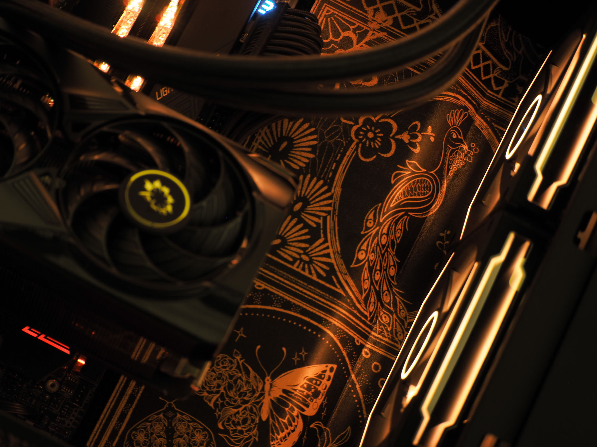 Art-deco engraving across the Orion backplate — peacock, florals, and a butterfly in gold