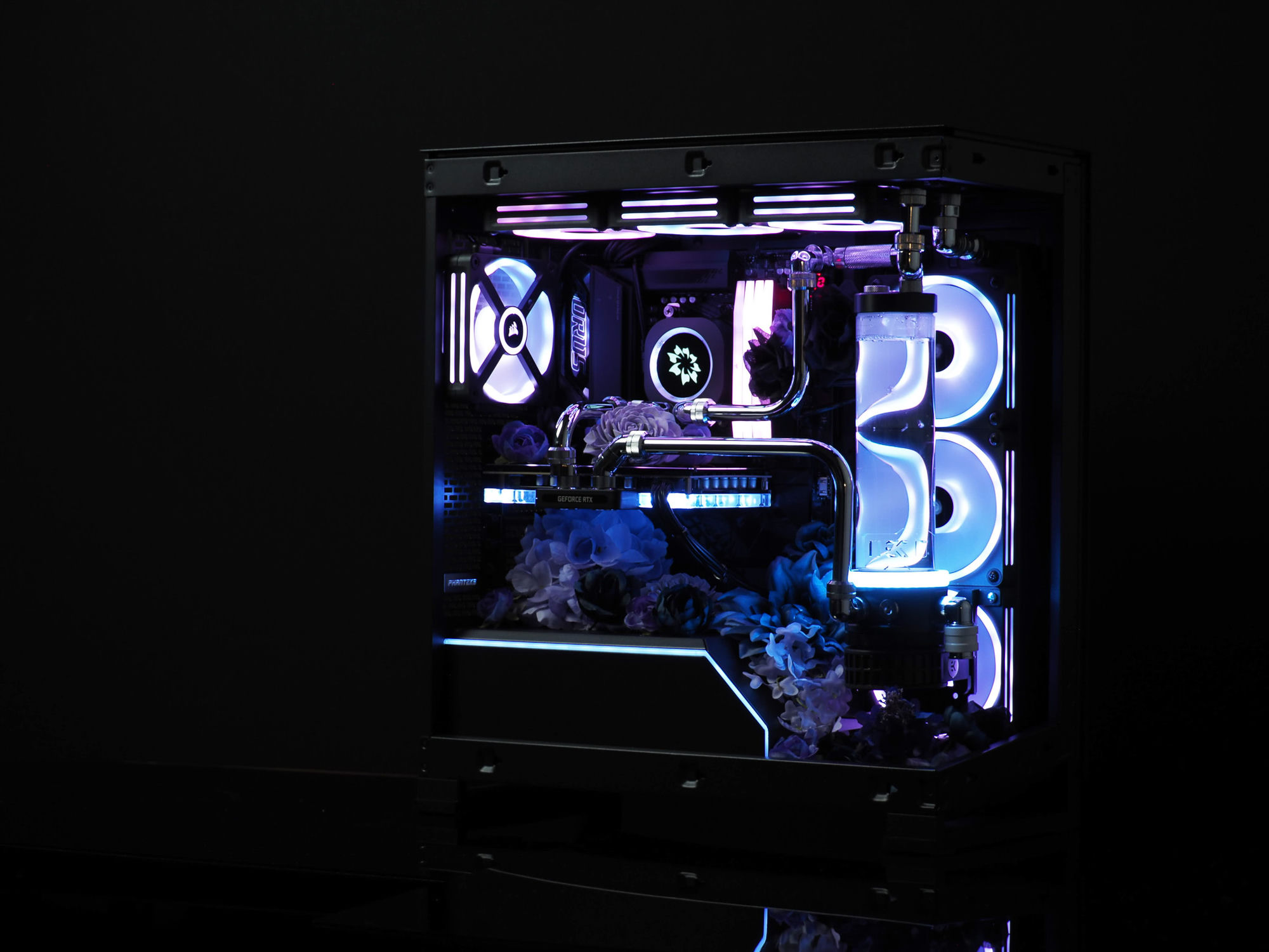 Night Rose — a floral watercooled build lit in blue and violet, blooms growing up through hand-bent chrome tubing