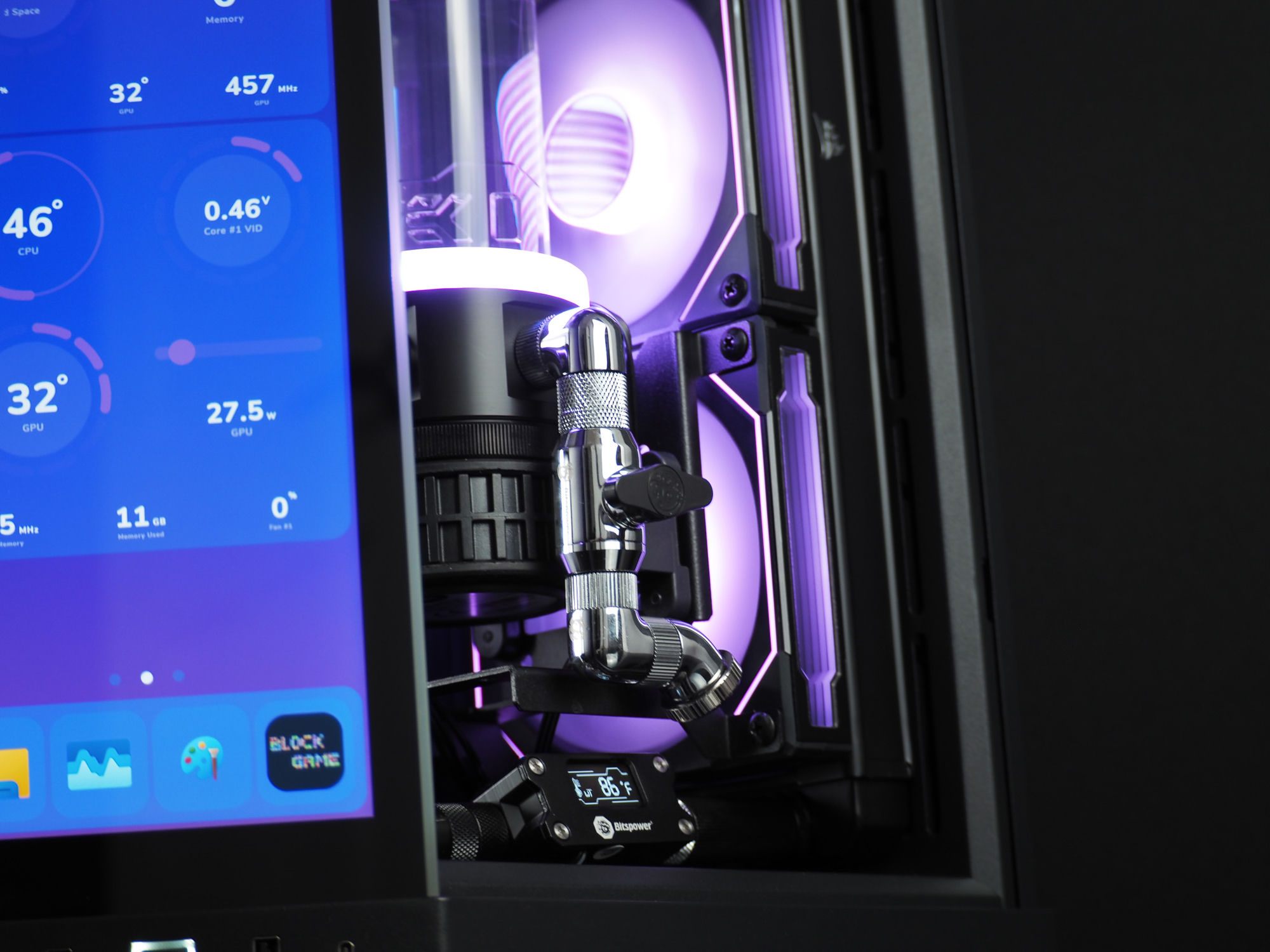 A polished chrome Bitspower fitting and frosted reservoir beside the front touchscreen