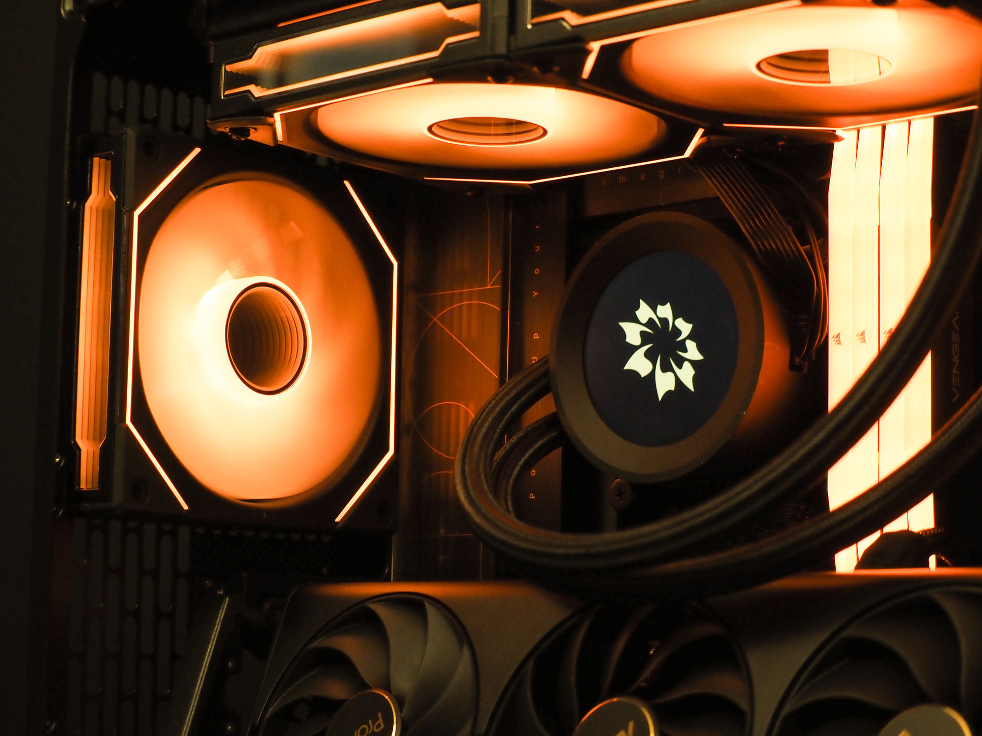 Nocturne’s interior lit in a low, warm orange — cooling fans, the flower-emblem pump, and glowing memory