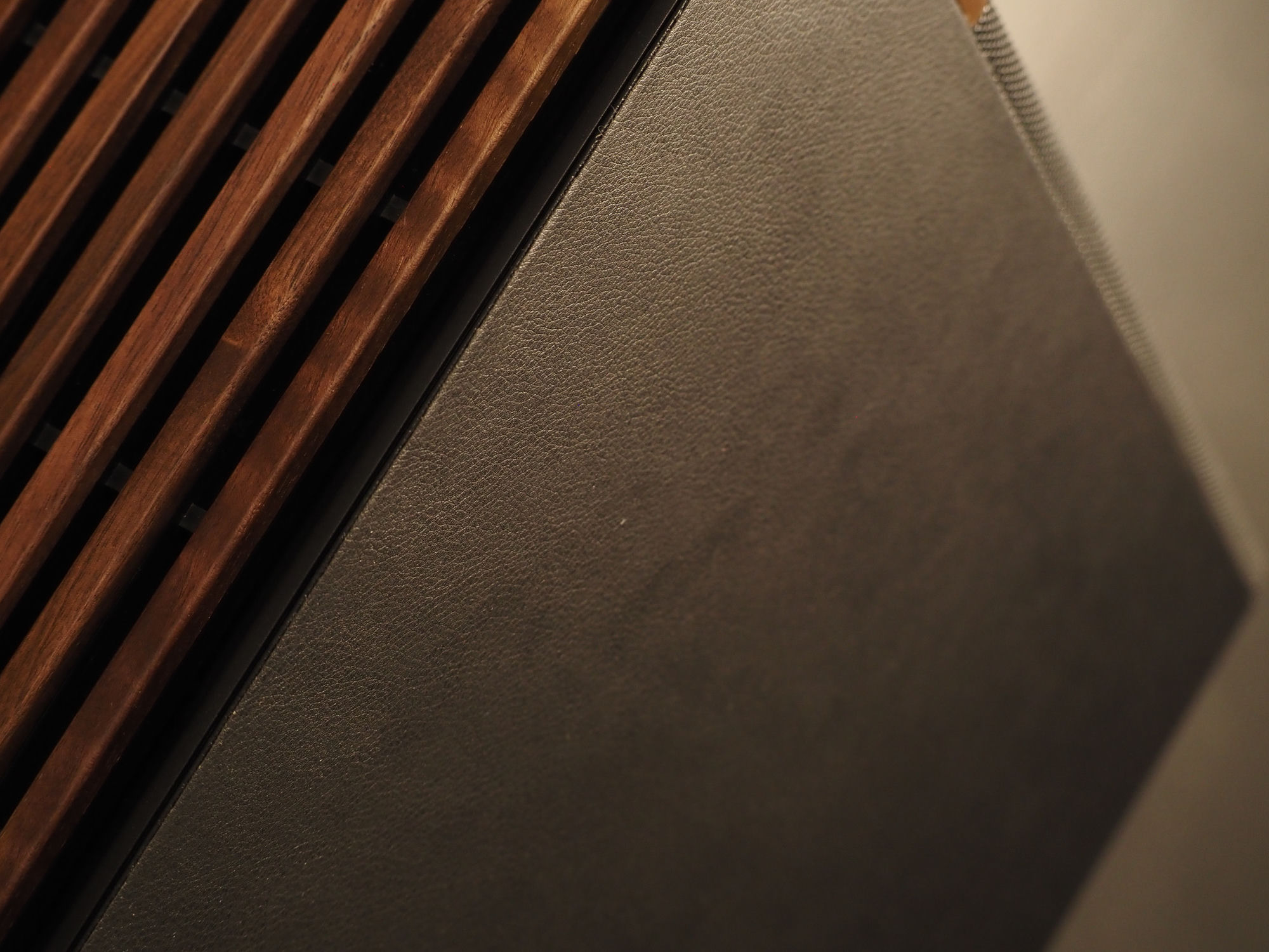 The wood-textured side panel meeting the vegan-leather back panel
