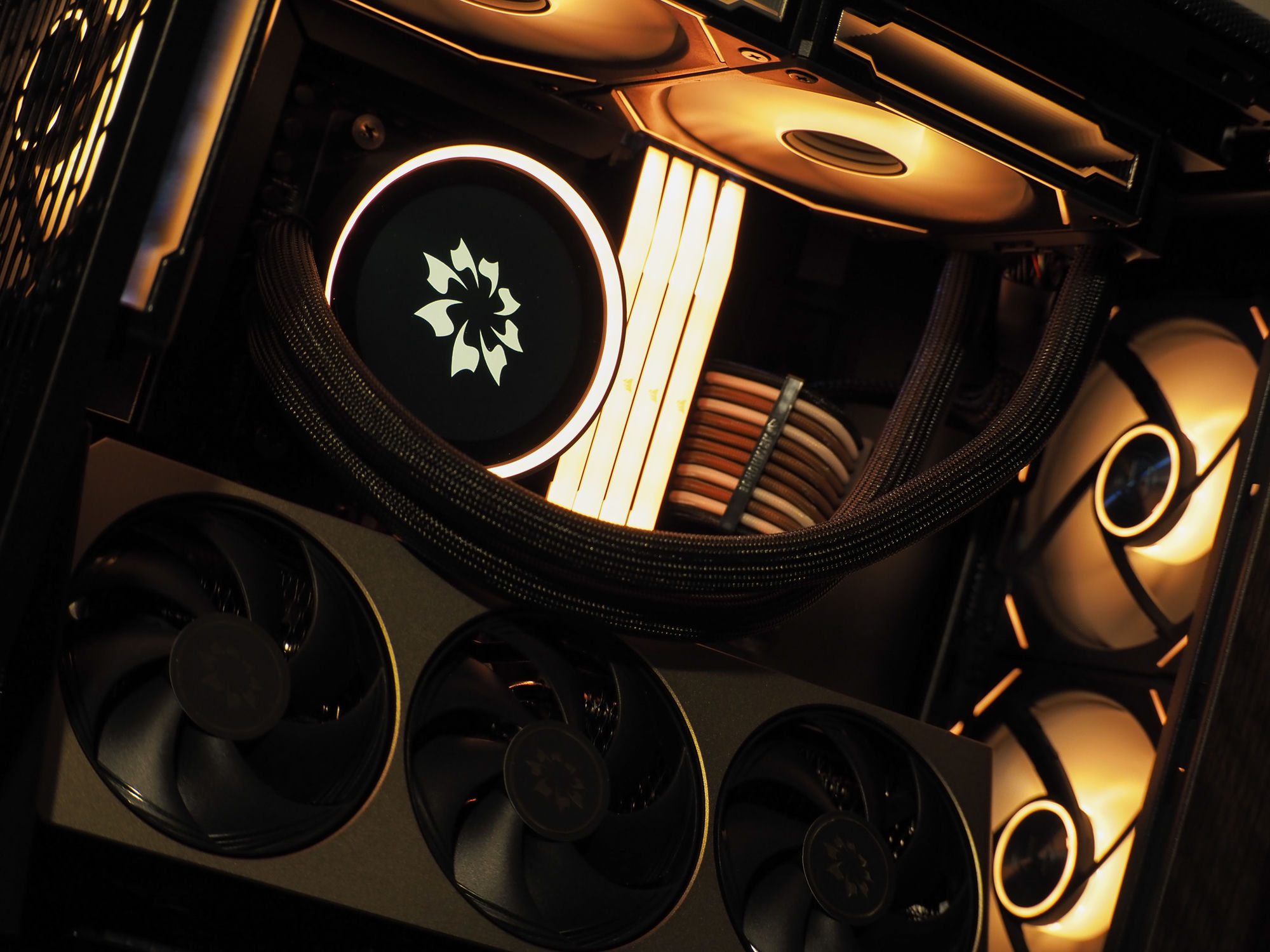 The NZXT Kraken Elite display with a new ring of light around the flower emblem, beside the black-and-brown Asiahorse cabling