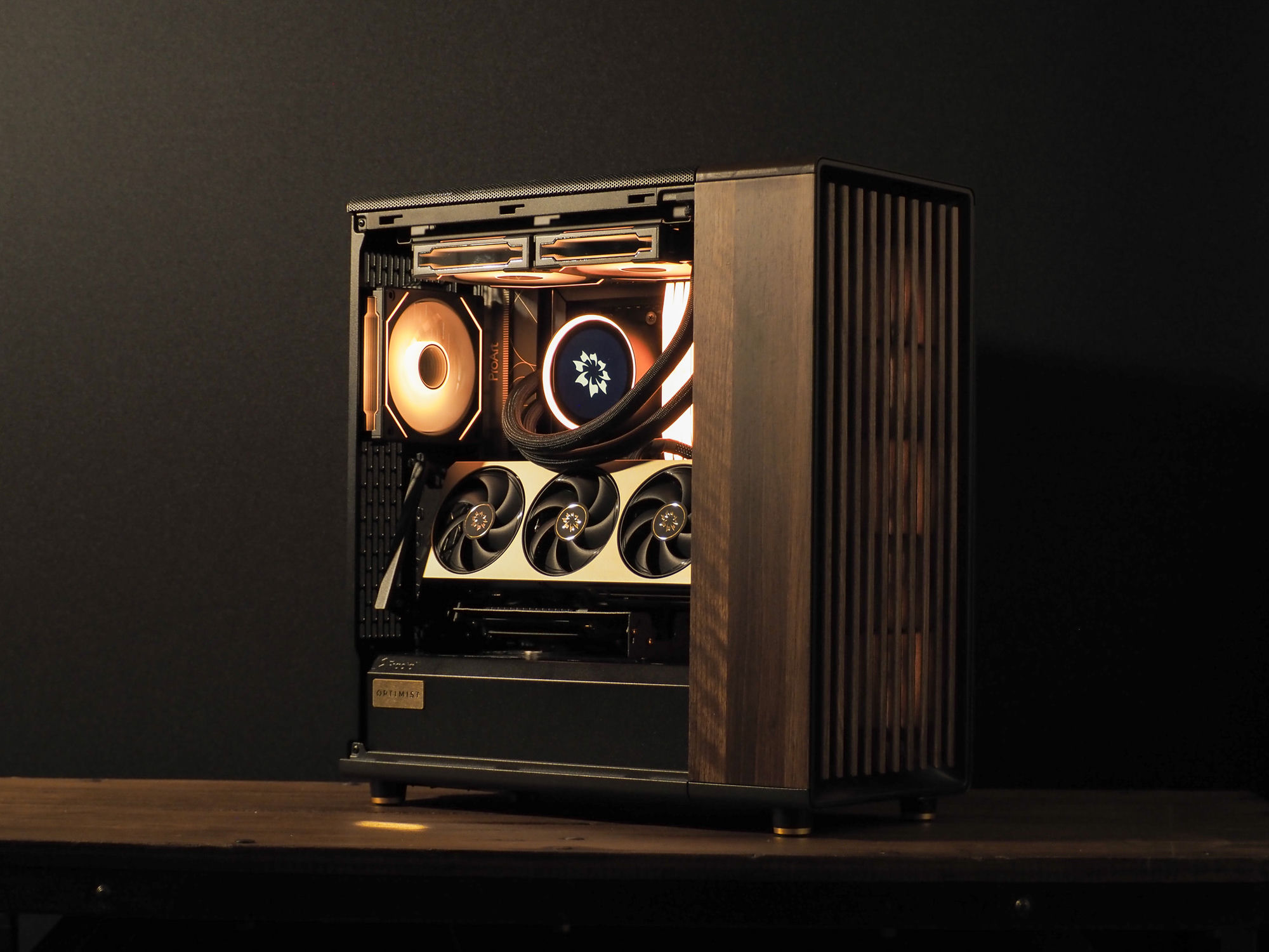 The refreshed Nocturne — a warm-lit ProArt build with a walnut side panel, Kraken Elite cooler and brass MSI Inspire card