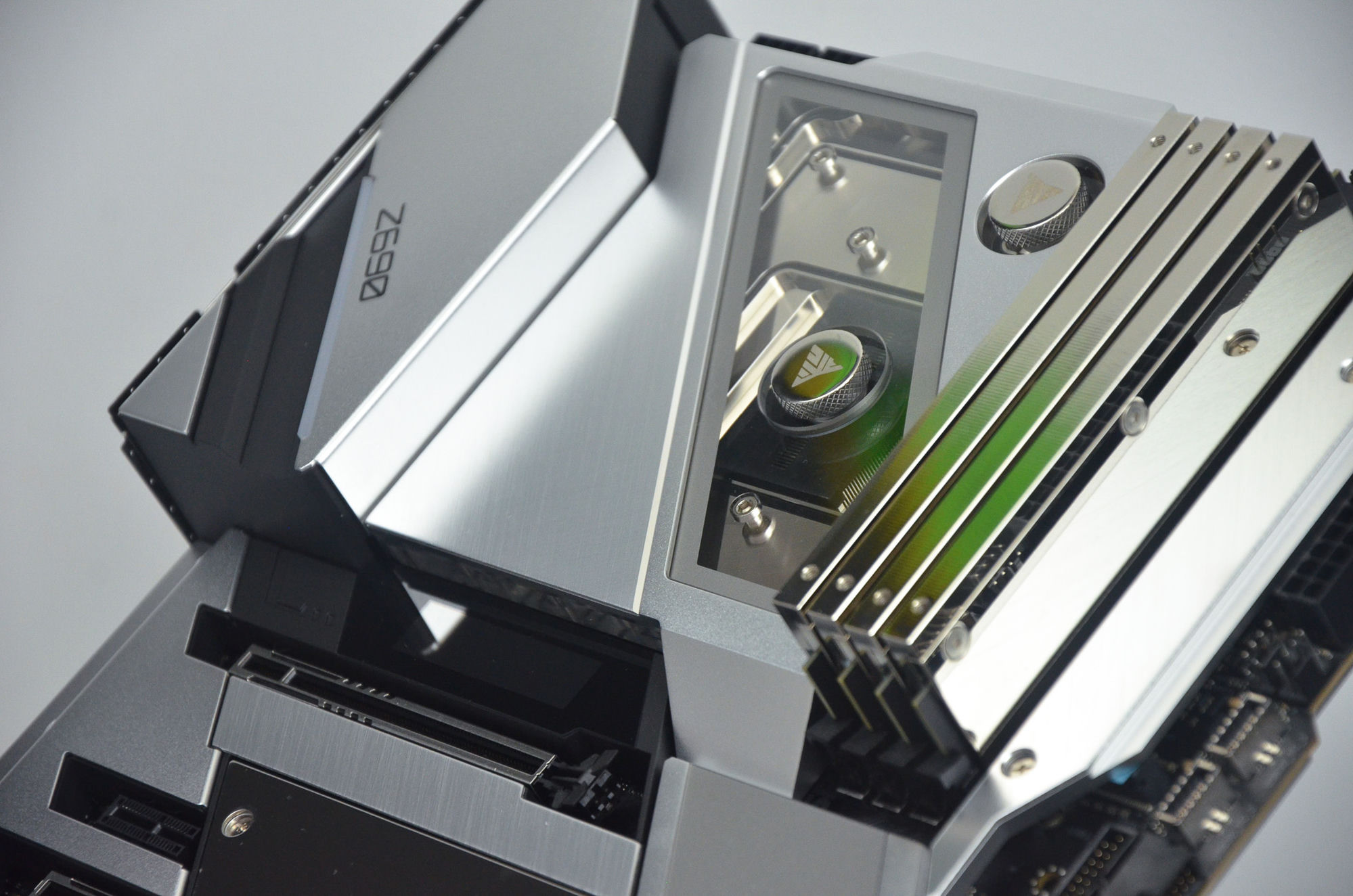 A brushed-silver monoblock water-cooling build over a Z690 motherboard — an early Optimist high-end system