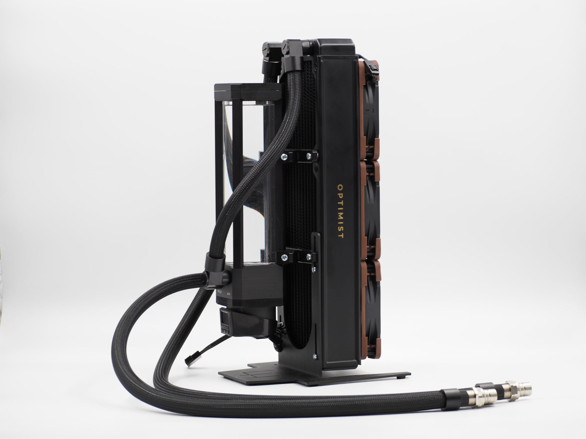 The standalone Optimist radiator tower in profile — reservoir tube, pump, and triple fans on a stand, sleeved lines ending in quick-disconnects