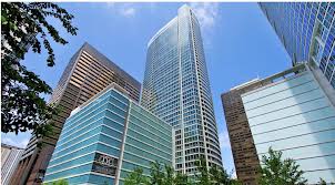 Exterior view of tall glass and steel residential towers in downtown Chicago with blue sky and surrounding buildings.