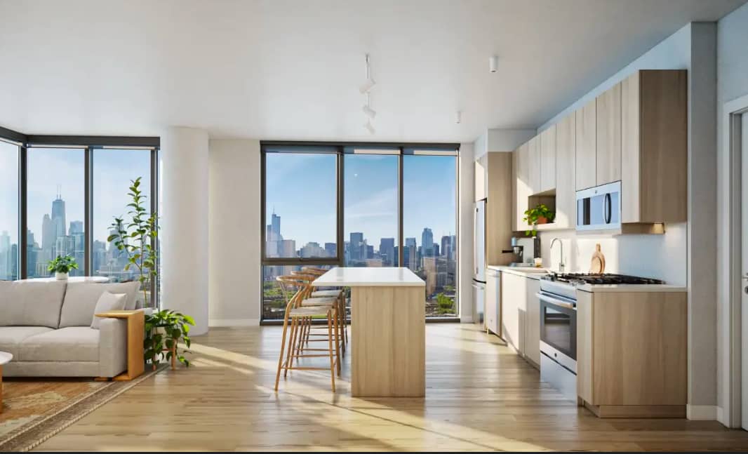 Open-concept kitchen and living room with light wood cabinetry, island seating, and expansive windows overlooking Chicago skyline.