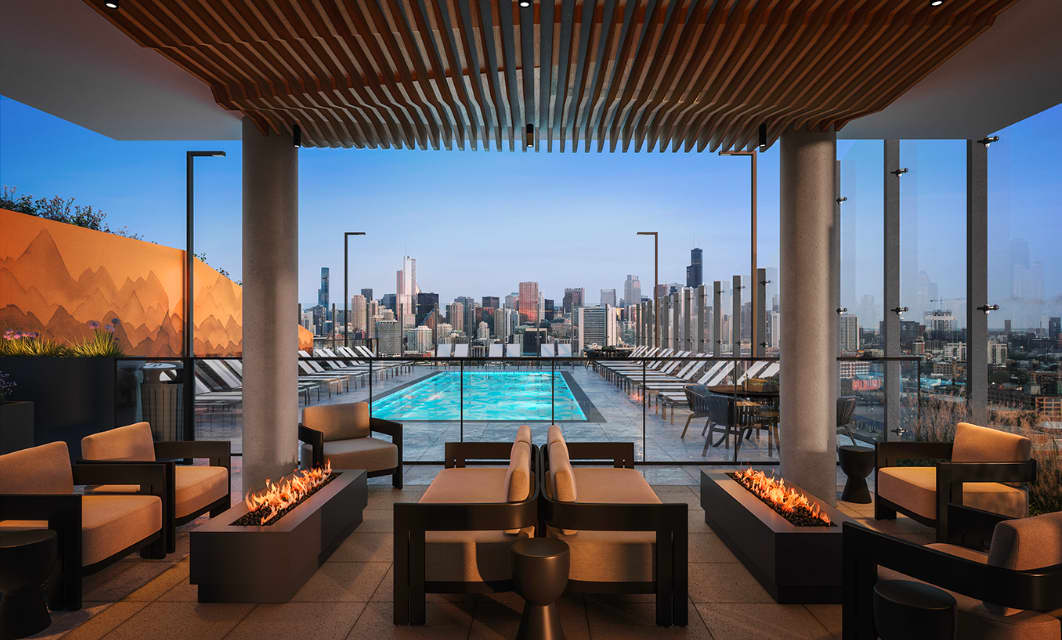 Rooftop terrace with heated swimming pool, lounge seating, fire pits, and Chicago skyline view.