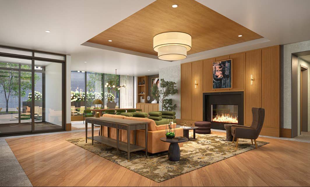 Open-concept living room with wood-paneled fireplace, orange and green seating, hardwood floors, and glass doors to patio.