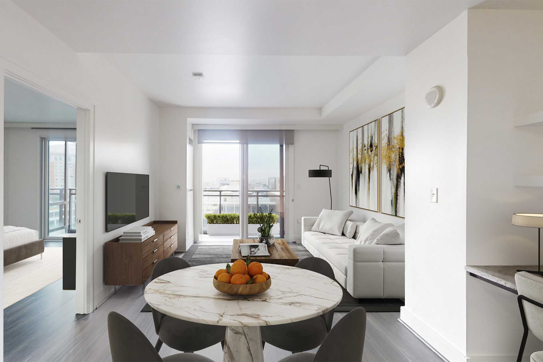 Open-concept apartment with round marble dining table, white sofa, TV, and floor-to-ceiling windows overlooking Boston skyline.