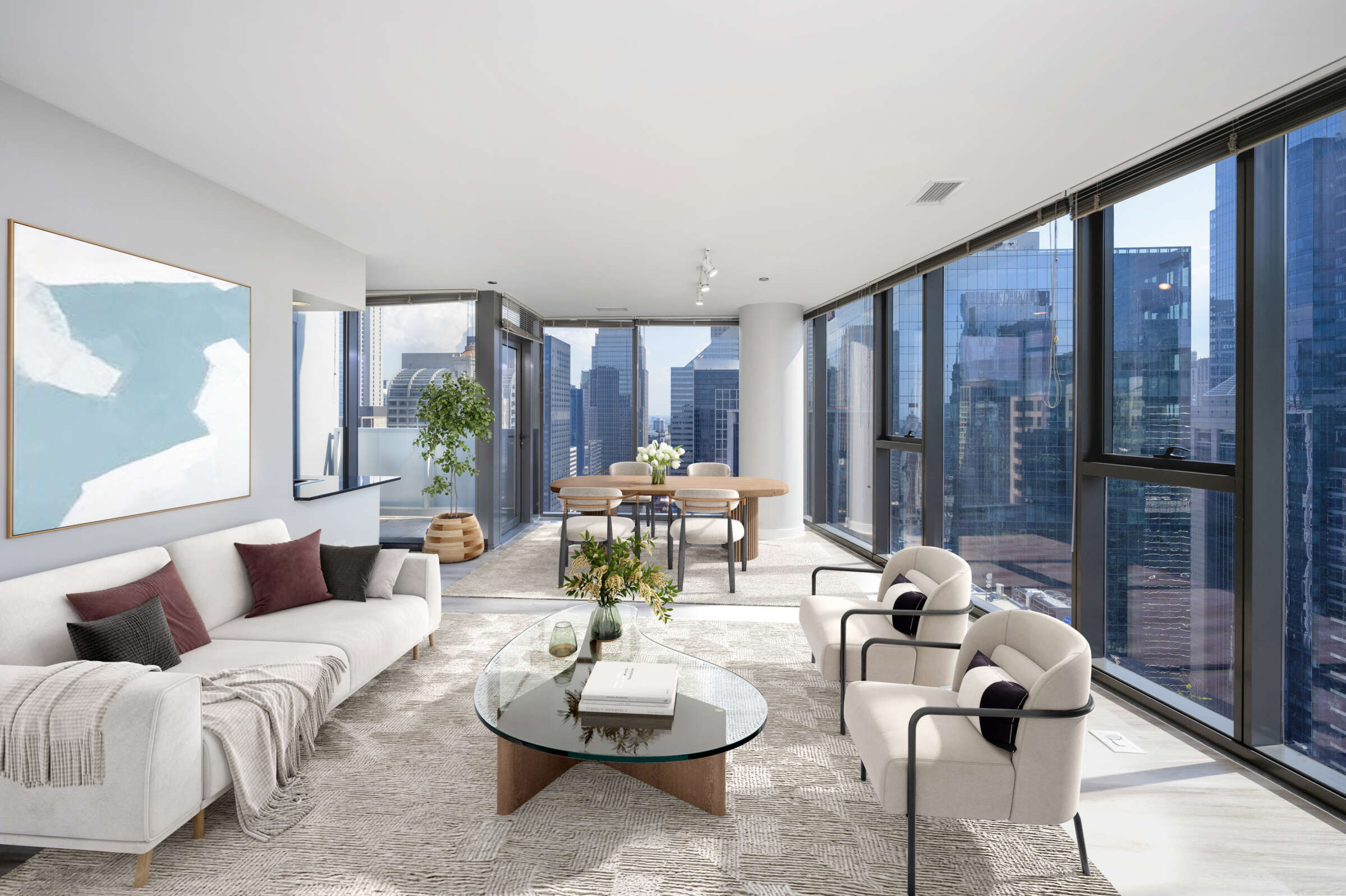 Modern living room with cream sofa, two curved armchairs, round glass coffee table, and expansive windows showing downtown Chicago skyscrapers.